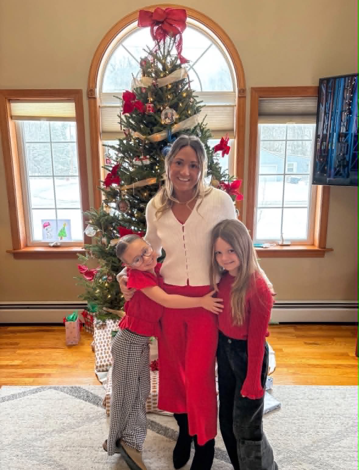 Nikki with her girls by the Christmas tree